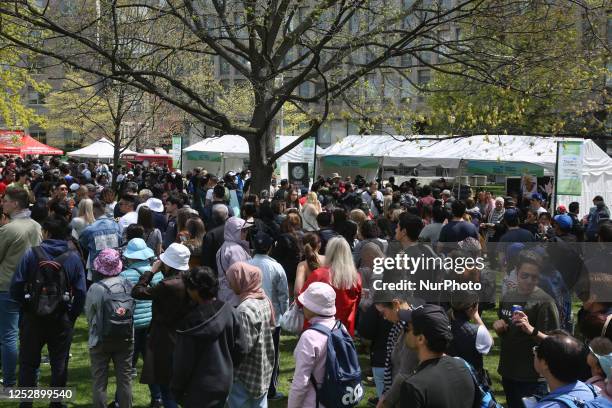 Canadians stand in line for free food during a Royal Fair celebrating the coronation of King Charles III at the Ontario Legislature Building in...