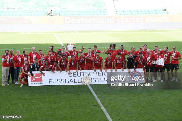 Players of FC Bayern Muenchen celebrate with the trophy to celebrate the championship following the Bundesliga match between VfL Wolfsburg and FC...