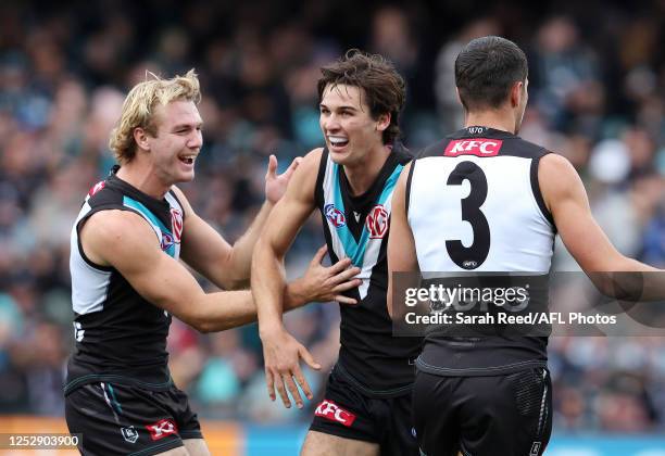 Connor Rozee of the Power celebrates a goal with Jason Horne-Francis of the Power and Ryan Burton of the Power during the 2023 AFL Round 08 match...