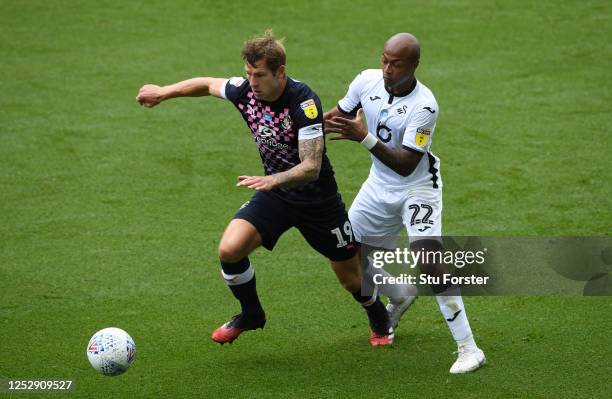 Swansea player Andre Ayew challenges James Collins of Luton during the Sky Bet Championship match between Swansea City and Luton Town at Liberty...