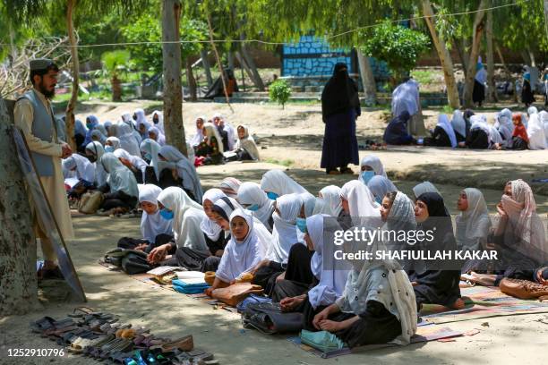 Afghan school girls attend a class at an open air primary school in Jalalabad on May 7, 2023.