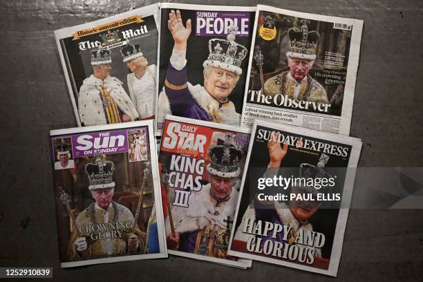 Picture shows a selection of newspapers with frontpage coverage of the coronation of Britain's Charles III and Britain's Queen Camilla in London on...