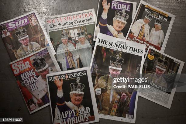 Picture shows a selection of newspapers with frontpage coverage of the coronation of Britain's Charles III and Britain's Queen Camilla in London on...