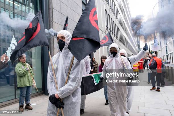 Activists from the environmental group Extinction Rebellion on a 'People's Picket' outside the Department for Energy Security and Net Zero carry a...