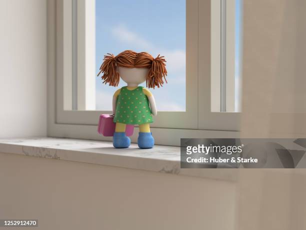 doll with suitcase looks dreamily out of the window - looking through a doll house photos et images de collection