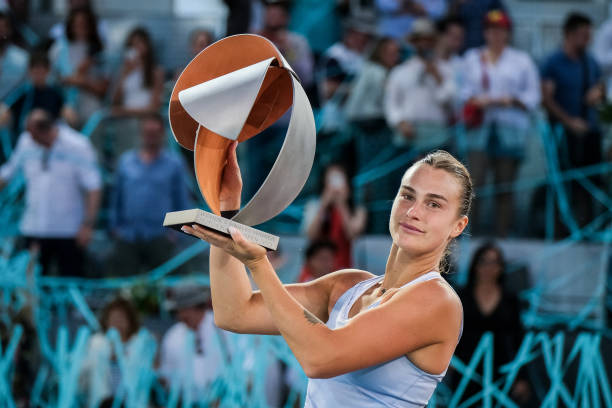 Aryna Sabalenka holds the winners trophy after a three set victory against Iga Swiatek of Poland during the Women's Final match on Day Thirteen of...