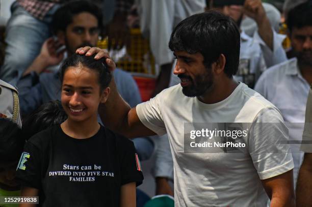 Indian Wrestler Bajrang Punia gives blessing to a girl during the ongoing protest against the allegations of sexual harassment to athletes by the...