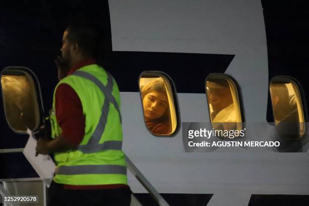 Venezuelan migrants sit on a plane bound for Venezuela at Chacalluta International Airport in Arica, Chile, on May 7, 2023. - A plane carrying more...