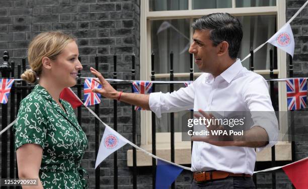 Britain's Prime Minister Rishi Sunak, gestures as he speaks to Finnegan Biden, granddaughter of U.S. President Joe Biden, as they attend the Big...