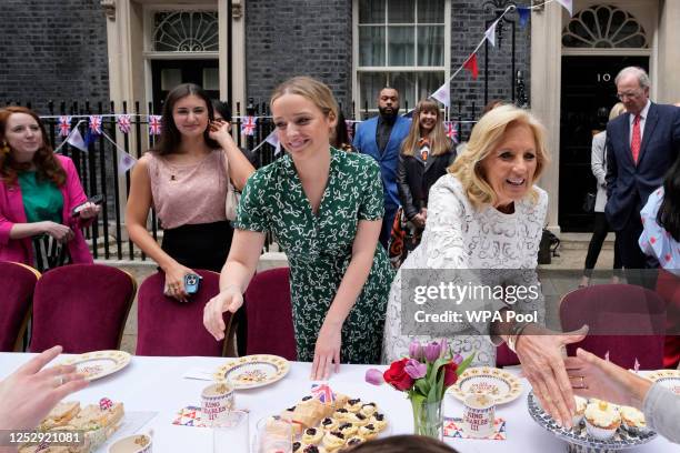 First Lady Jill Biden and granddaughter Finnegan Biden go to shake hands with other guests as they attend the Big Lunch party at Downing Street on...