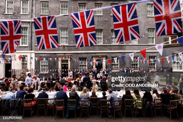 Guests attends a Coronation Big Lunch organised in Downing Street by Britain's Prime Minister and his wife, in London, on May 7, 2023. - Thousands of...