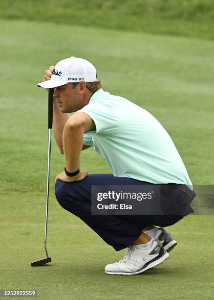 Patton Kizzire of the United States lines up a putt on the 18th green during the third round of the Travelers Championship at TPC River Highlands on...