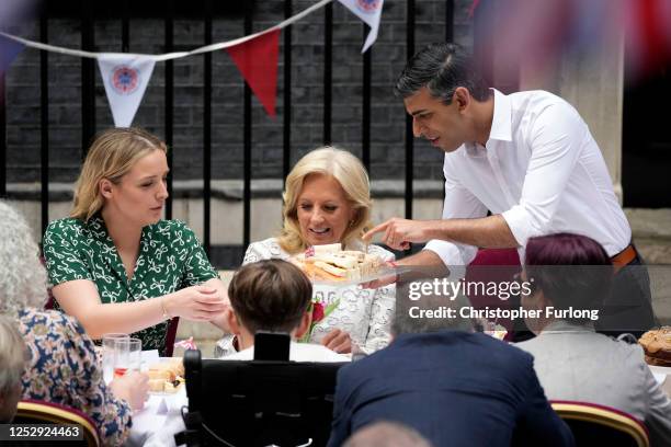 First Lady of the United States of America, Dr. Jill Biden, and granddaughter Finnegan Biden share cake with Prime Minister Rishi Sunak during a...