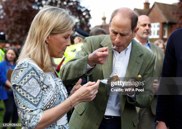 Britain's Prince Edward, Duke of Edinburgh and Sophie, Duchess of Edinburgh taste a coronation chicken pie as they attend a Big Lunch with residents...