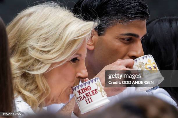 Britain's Prime Minister Rishi Sunak and US Lady Jill Biden drink a cup of tea during a Coronation Big Lunch organised in Downing Street, in London,...