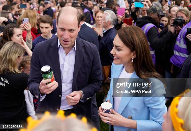 Prince William, Prince of Wales holds a can of 'Return of the King' Coronation Ale as he stands next to Catherine, Princess of Wales as they speak to...