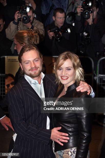 Kate Winslet poses for photographers with her husband film director Jim Threapleton at the premiere of "Holy Smoke" at the Odeon West End in London...