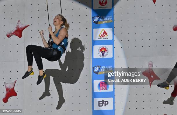 Poland's speed climber Aleksandra Miroslaw reacts after winning against Indonesia's speed climber Desak Made Rita Kusuma Dewi as they compete in...