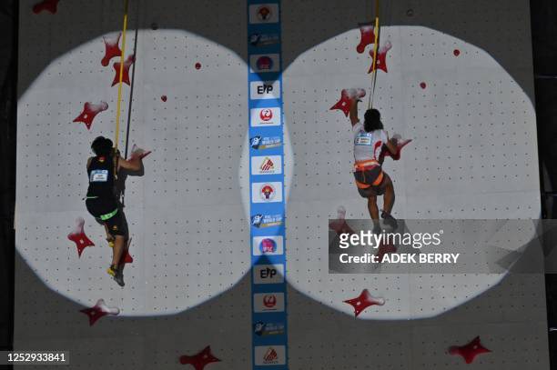 China's speed climber Wang Xinshang and Indonesia's Raharjati Nursamsa compete in the men's final speed discipline at the IFSC World Cup Jakarta 2023...