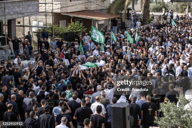 Palestinians carry the dead body of Diyar Omari , a Palestinian youth who was shot dead by an lsraeli settler in Gan Ner settlement, during his...