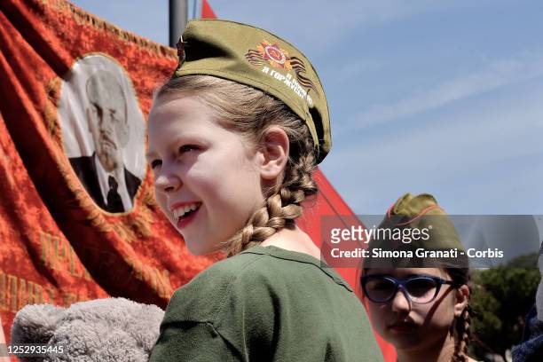 Children in front of the banner depicting Lenin gather in Piazza San Giovanni to celebrate the Immortal Regiment on the anniversary of the Soviet...