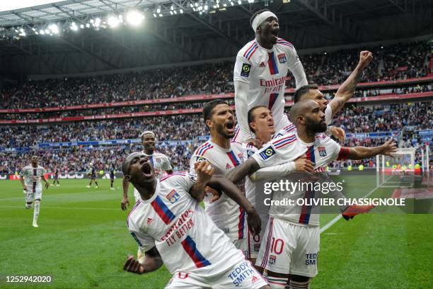 Lyon's French forward Alexandre Lacazette celebrates with teammates after winning the French L1 football match between Olympique Lyonnais and...