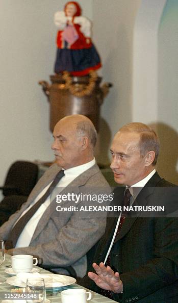 Putin Tea Or Window Russian President Vladimir Putin talks over a cup of tea as famous ...