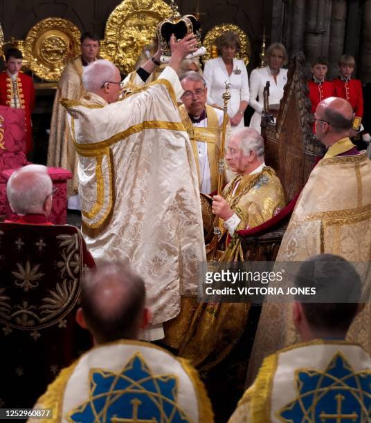 The Archbishop of Canterbury Justin Welby places the St Edward's Crown onto the head of Britain's King Charles III, sitting in King Edward's Chair,...