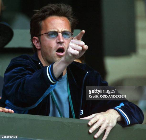 Actor Matthew Perry reacts after a point made my his girl friend Jennifer Capriati of the US during her quarter final round match against Serena...