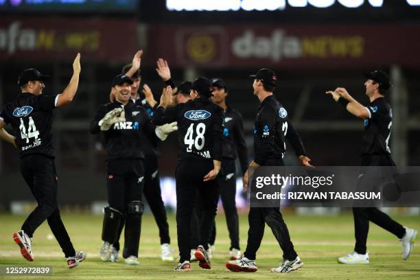 New Zealand's cricketers celebrate the dismissal of Pakistan's Agha Salman during the fifth and final One-Day International cricket match between...