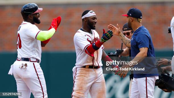 Michael Harris II reacts after his game winning double with Marcell Ozuna and Eddie Rosario of the Atlanta Braves during the twelfth inning against...