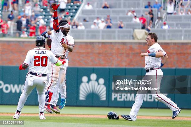 Michael Harris II reacts after his game winning double with Marcell Ozuna and Chadwick Tromp of the Atlanta Braves during the twelfth inning against...