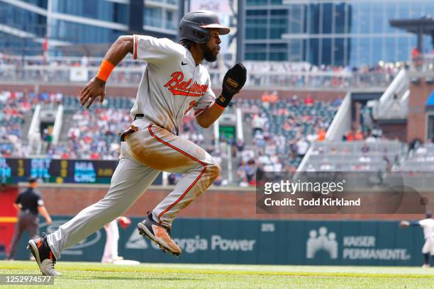 Cedric Mullins of the Baltimore Orioles races in to score after an Anthony Santander single during the tenth inning against the Atlanta Braves at...