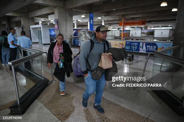 Venezuelan migrants walk upon arrival at the Simon Bolivar International Airport in Maiquetia, La Guaira State, Venezuela, on May 7, 2023. - A plane...