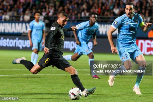 Paris Saint-Germain's Italian midfielder Marco Verratti shoots the ball next to Troyes' French defender Adil Rami during the French L1 football match...