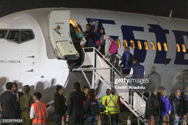 Migrants enter the plane of the Venezuelan airline Estelar, which repatriated 126 Venezuelan citizens who were stranded on the Chilean-Peruvian...