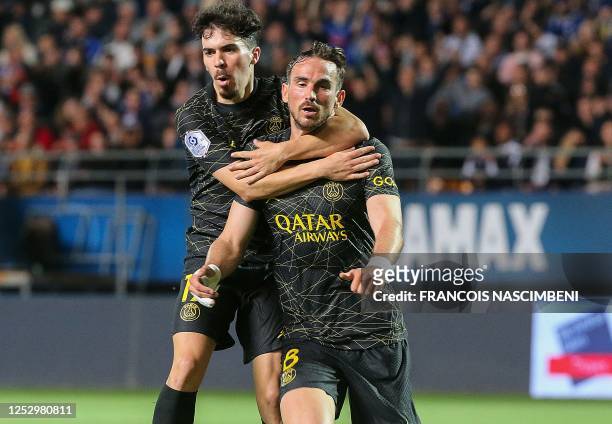Paris Saint-Germain's Spanish midfielder Fabian Ruiz celebrates with Paris Saint-Germain's Portuguese midfielder Vitinha after he scored the third...