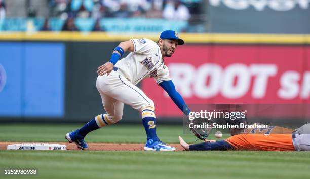 Second baseman Jose Caballero of the Seattle Mariners tags out Kyle Tucker of the Houston Astros, who was trying to steal second base during the...