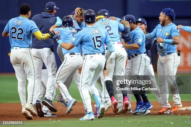 Members of the Tampa Bay Rays celebrate a win over the New York Yankees during the 10th inning of a baseball game at Tropicana Field on May 7, 2023...