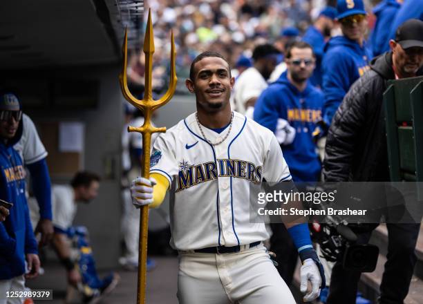 Julio Rodriguez of the Seattle Mariners poses with a trident in the dugout after hitting a solo home run against the Houston Astros during the second...