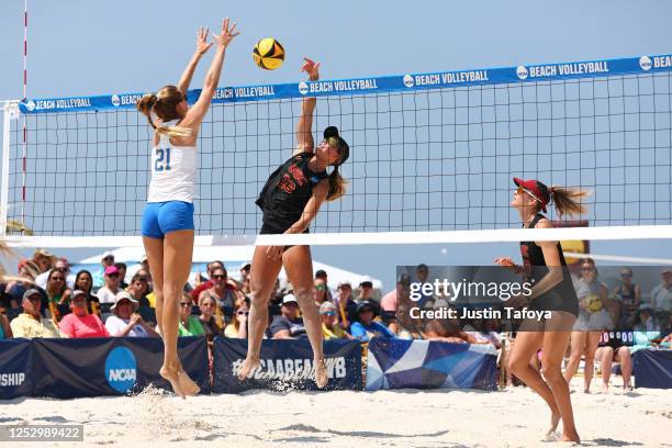 Madison Shields of the USC Trojans and Abby Van Winkle of the UCLA Bruins meet at the net during the Division I Women's Beach Volleyball Championship...