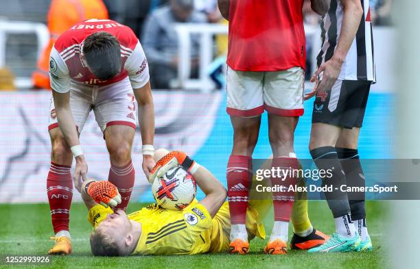 Arsenal's Aaron Ramsdale lays injured during the Premier League match between Newcastle United and Arsenal FC at St. James Park on May 7, 2023 in...