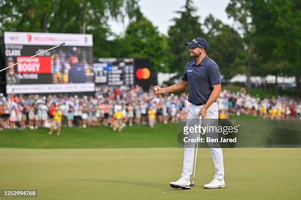 Wyndham Clark celebrates after making the winning putt on the 18th green during the final round of the Wells Fargo Championship at Quail Hollow Club...