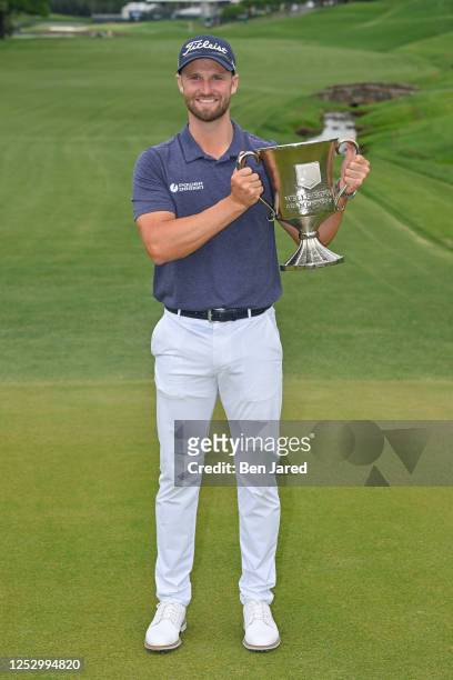 Wyndham Clark holds the trophy near the 18th green after the final round of the Wells Fargo Championship at Quail Hollow Club on May 7, 2023 in...