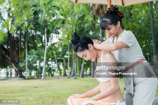 woman receiving massage - bali massage stock-fotos und bilder