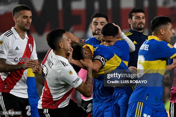 River Plate's forward Matias Suarez fight with Boca Juniors' midfielder Guillermo Fernandez during their Argentine Professional Football League...