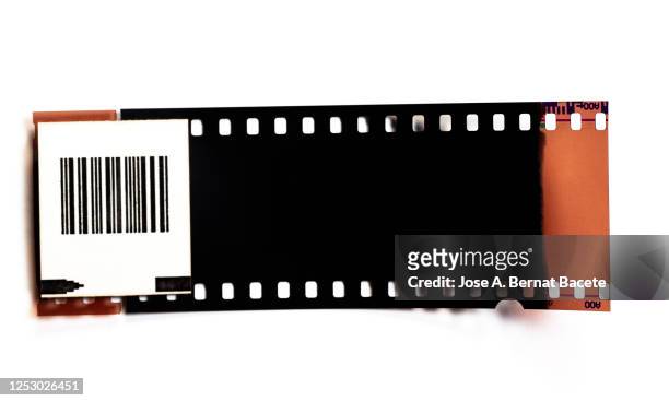 color negative 35mm film stripes on a white background. - diastreifen stock-fotos und bilder
