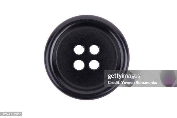 black sewing button isolated on white background - button fotografías e imágenes de stock