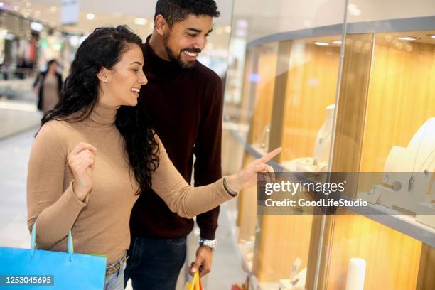 couple choosing jewelry - jewellery shopping stock pictures, royalty-free photos & images