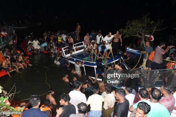 In this photograph taken on May 7 people carry out rescue operation at the site of a boat accident in Tanur, in Malappuram district of India's Kerala...